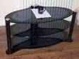 Smoked Glass TV Stand. A1 Condition, 1 Heavy 3 Layer Oval....